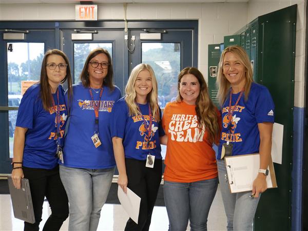 5 teachers smiling at camera
